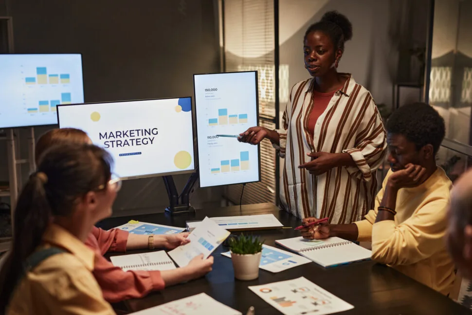 A marketer presenting a campaign plan on a wall of notes
