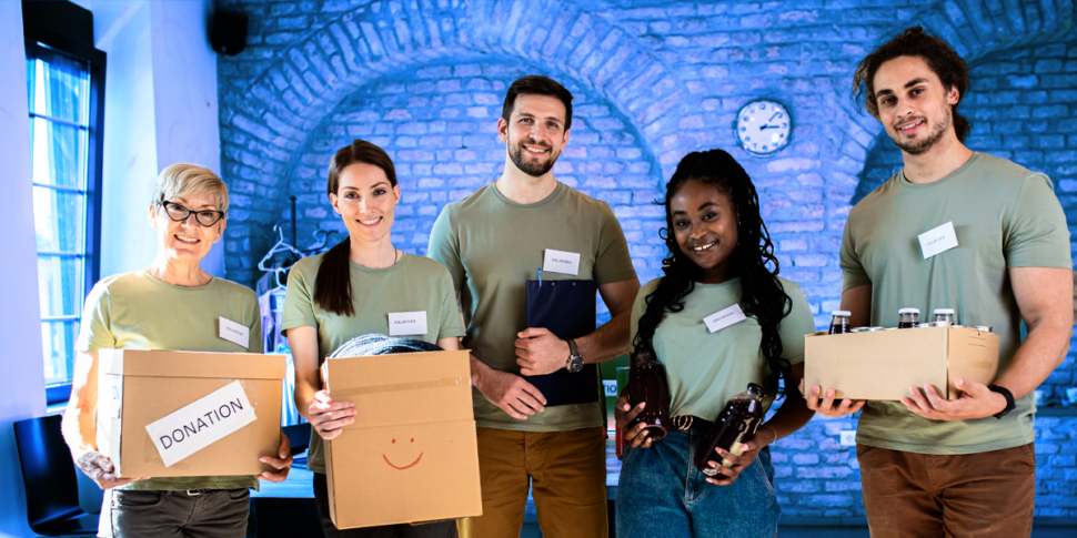 Non Profit volunteer team smiles at camera