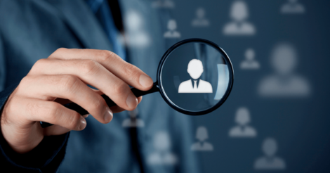 A magnifying glass over audience profile icons