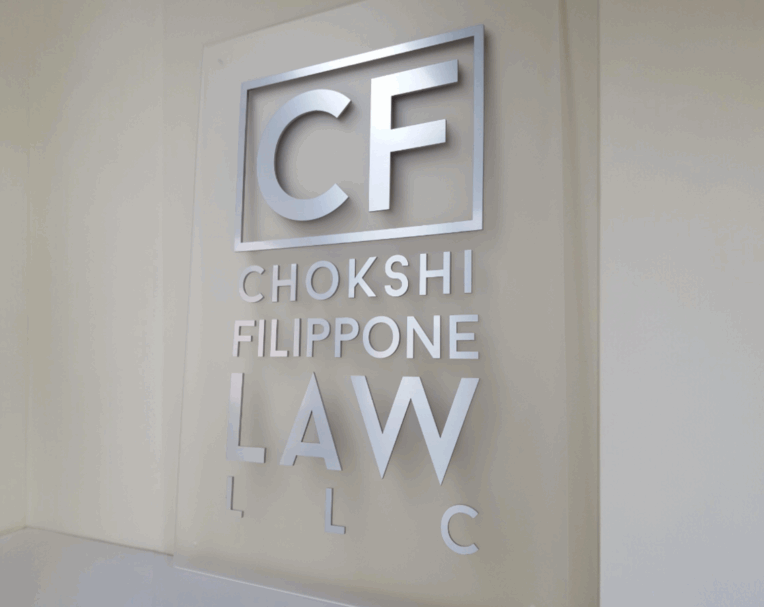 Custom acrylic office sign for CF Law featuring standoff mounting and professional branding