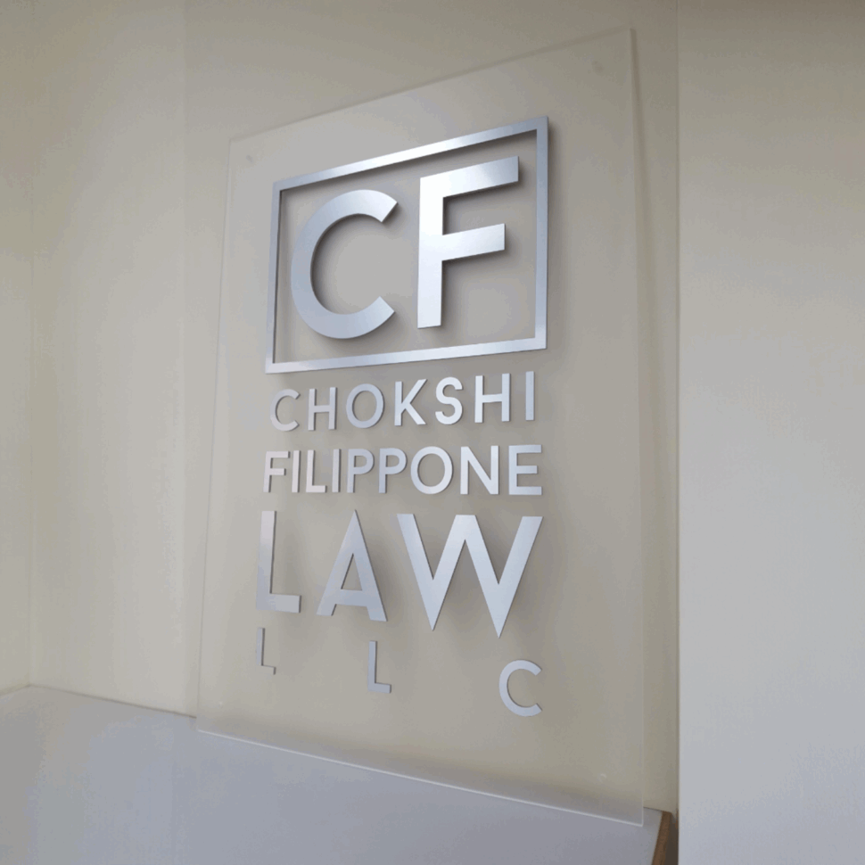 Custom acrylic office sign for CF Law featuring standoff mounting and professional branding