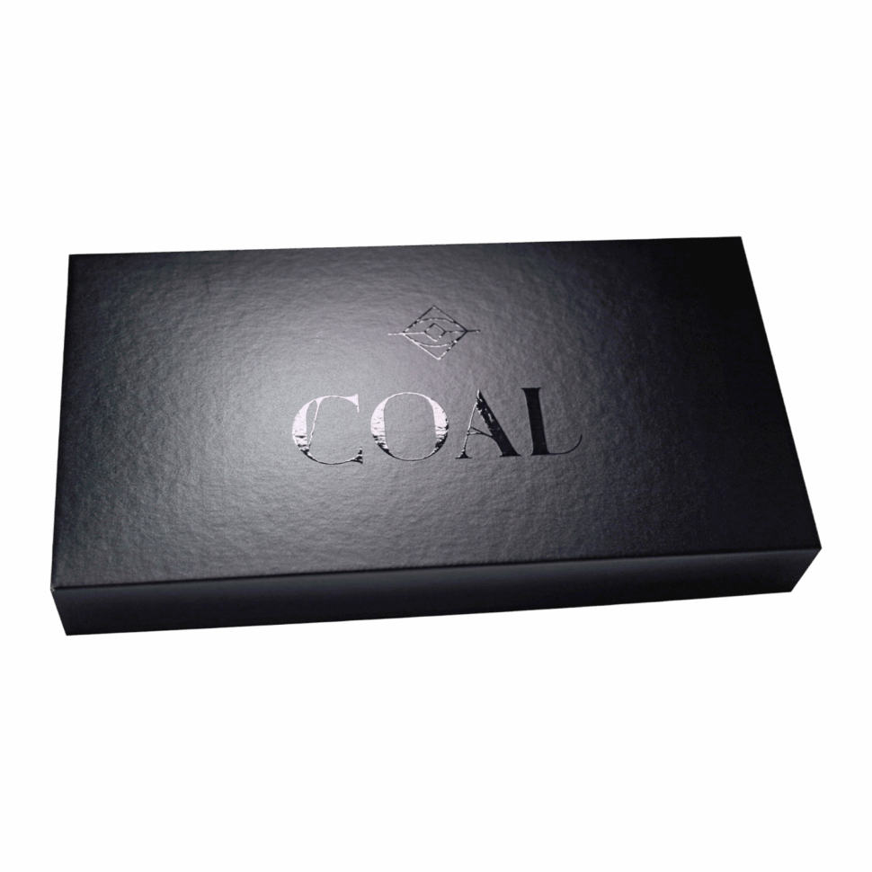 Custom mailer box featuring a coal-themed design, branded black foil, and product insert