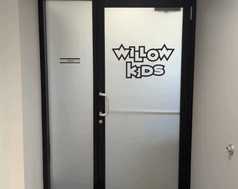 Door graphics for Willow Kids featuring welcoming design for family areas.