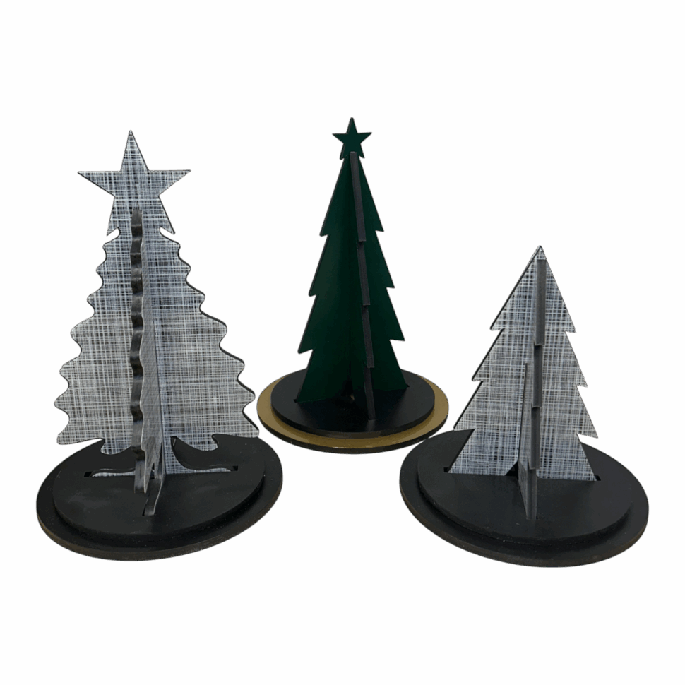Set of three tabletop holiday tree displays with custom die-cut shapes and printed textures on round bases for seasonal decoration