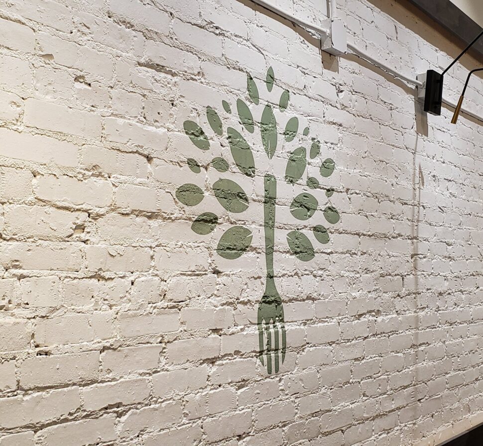 Custom vinyl wall sign for KOYA featuring clean typography and modern placement in a wellness-focused interior space
