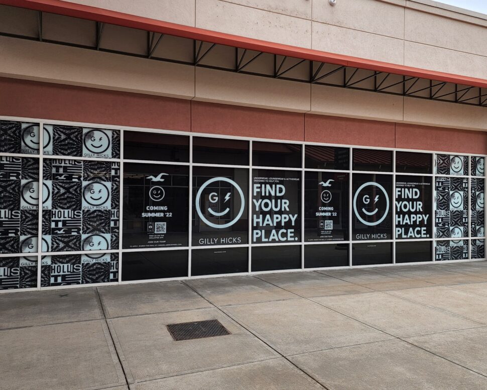 White vinyl window graphics for Hollister providing branded privacy and clean, modern storefront design