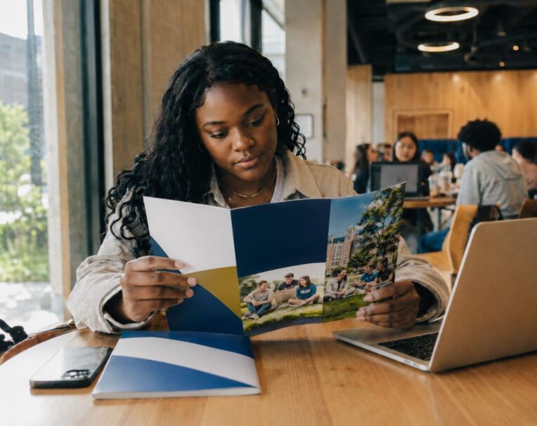 Diverse student holding personalized college direct mail piece