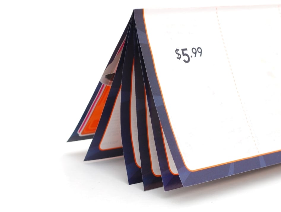 Saddle-stitched booklet fanned open, showing its nested folded pages
