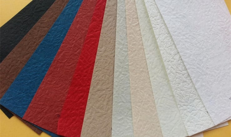 Fan of colored and textured specialty paper swatches